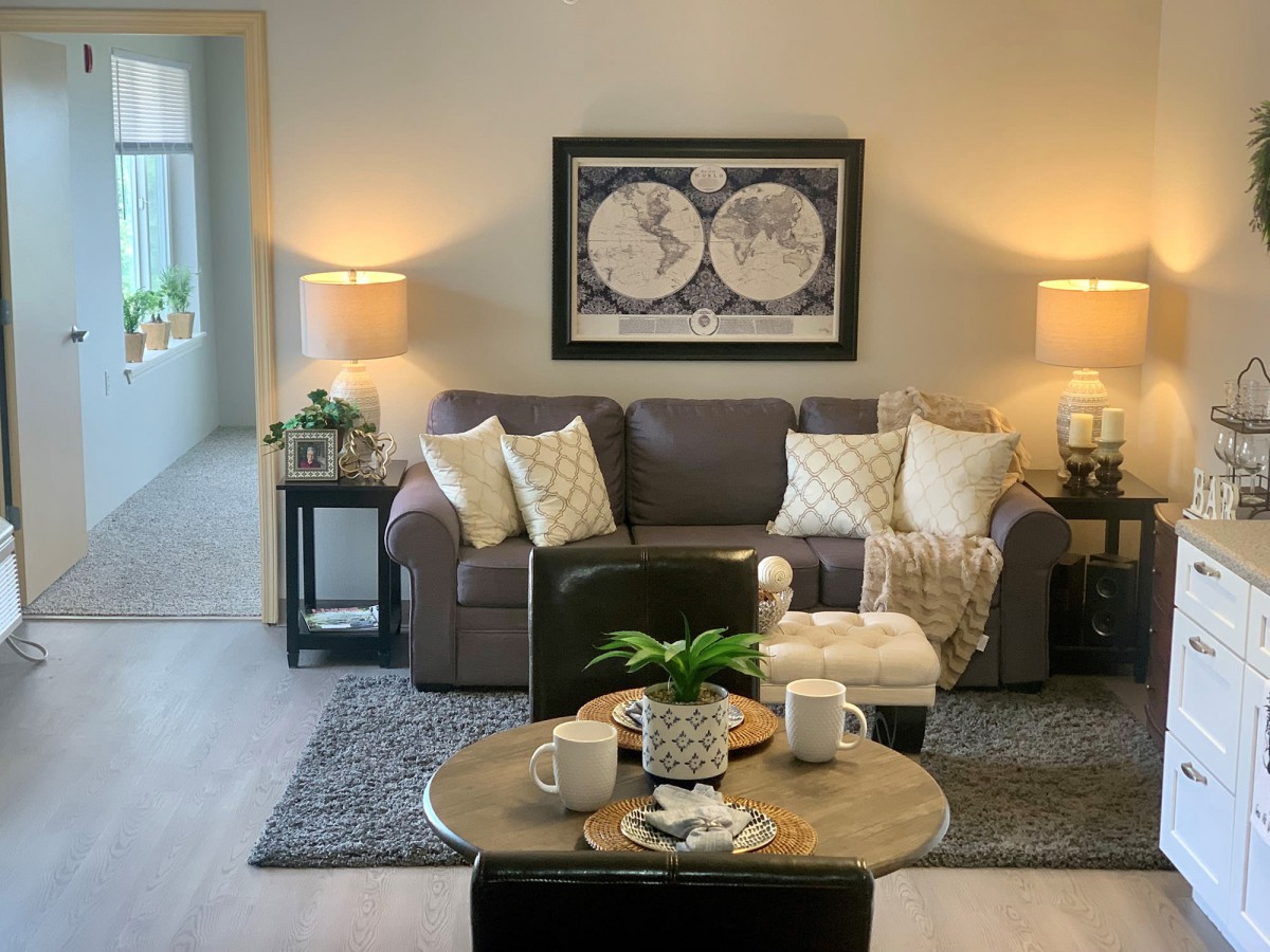 A cozy living room with a sofa, coffee table, and stylish decor.