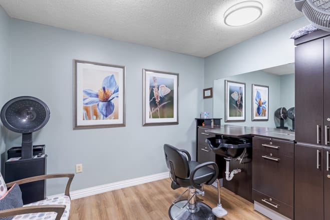 A modern hair salon interior with stylish artwork on the walls.