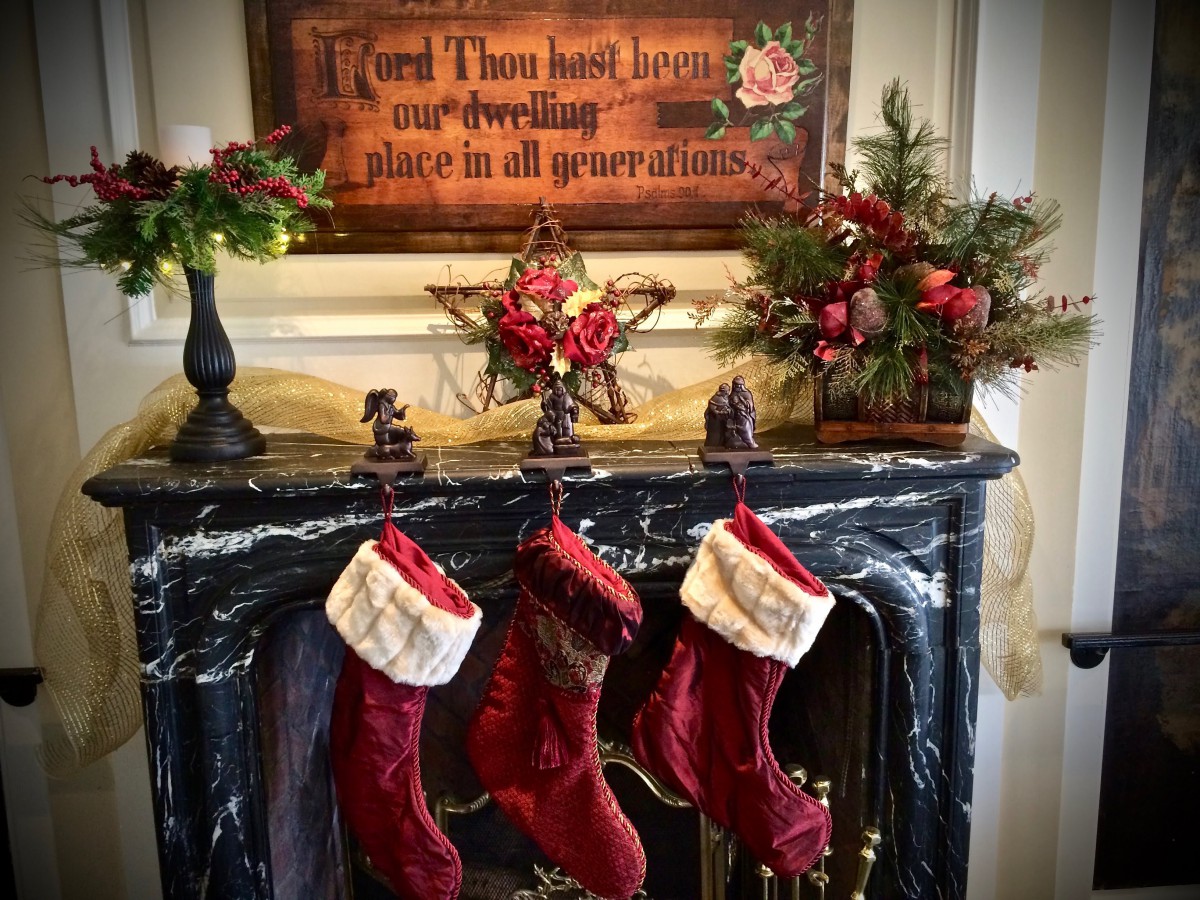 A beautifully decorated fireplace mantel with Christmas stockings and festive garlands.