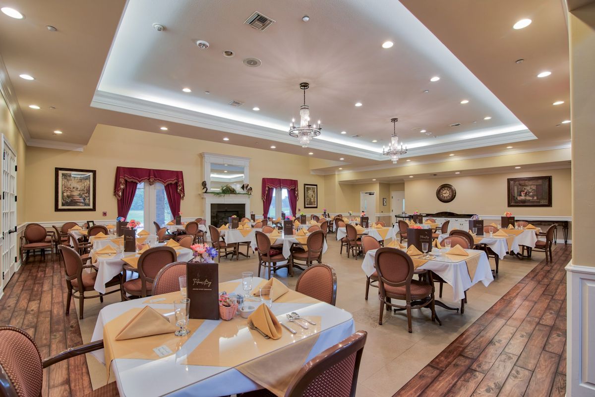 Elegant dining room with neatly arranged tables and warm lighting.