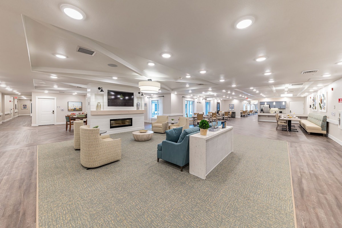 A spacious and modern lounge area with ample seating and warm lighting.