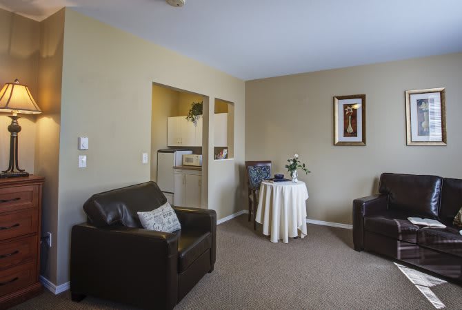 A cozy living room with comfortable seating and a small dining area.