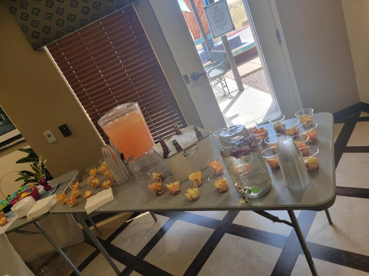 A table set up with drinks and snacks for an indoor gathering.