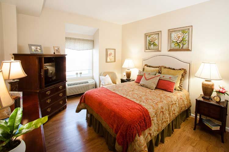 A cozy bedroom with warm lighting and elegant decor.