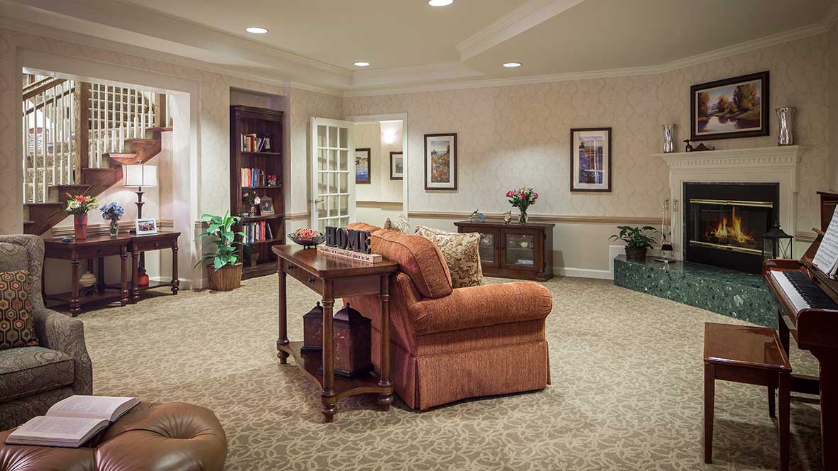 A cozy living room with a comfortable sofa, coffee table, and bookshelf.