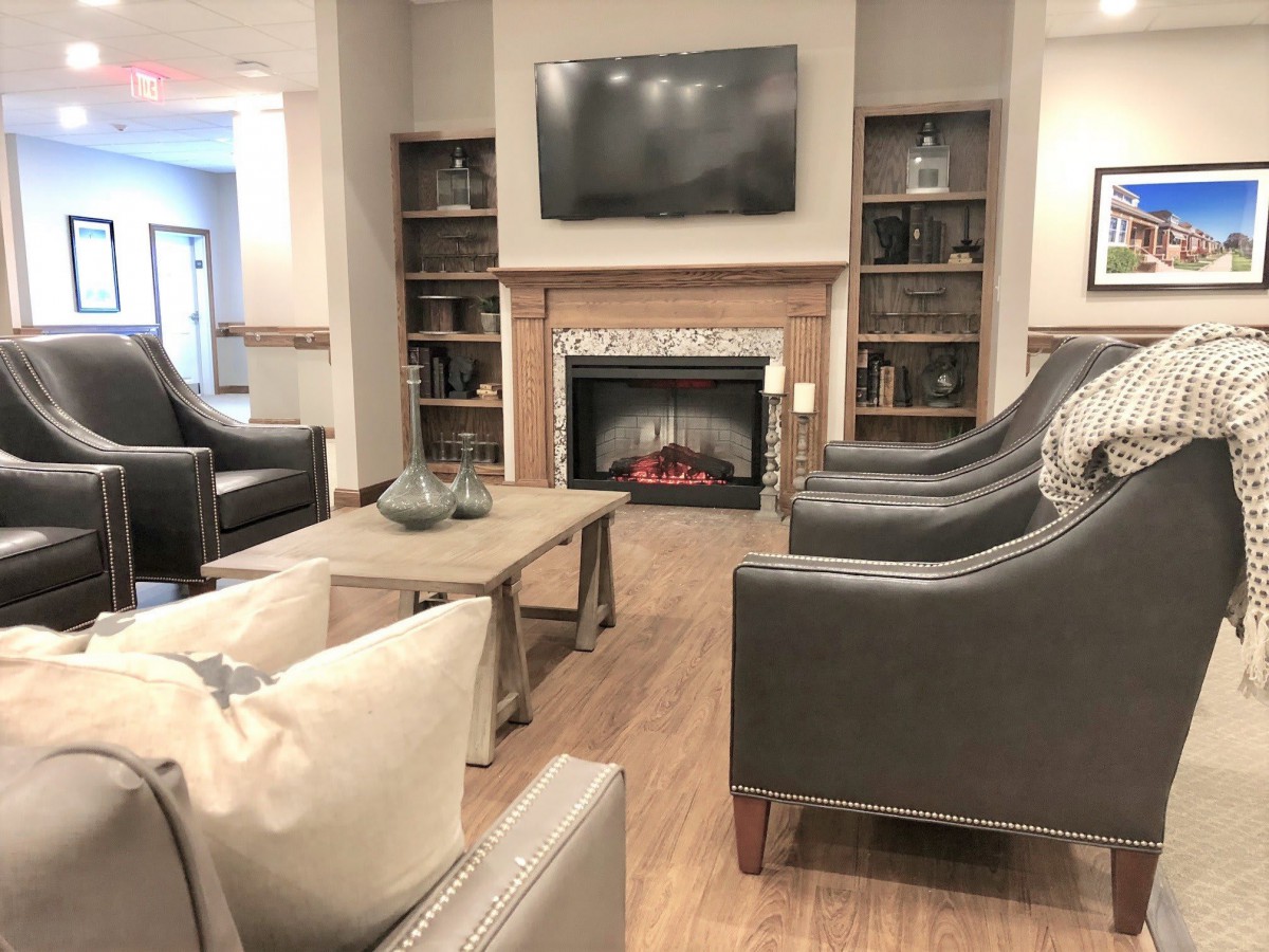 A cozy living room with a fireplace, television, and comfortable seating.