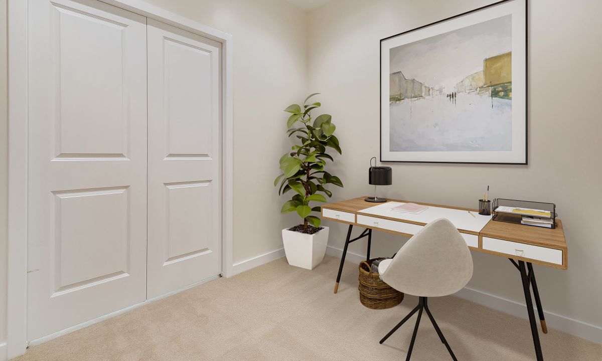 A minimalist home office with a sleek desk, modern chair, and indoor plant.