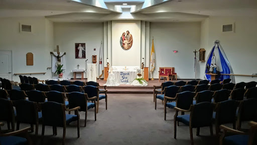 A serene interior view of a chapel, featuring an altar and seating arrangements.