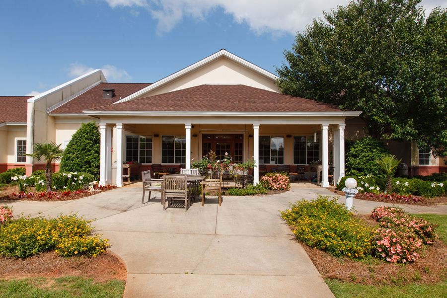 A cozy house with a spacious porch and well-maintained garden.