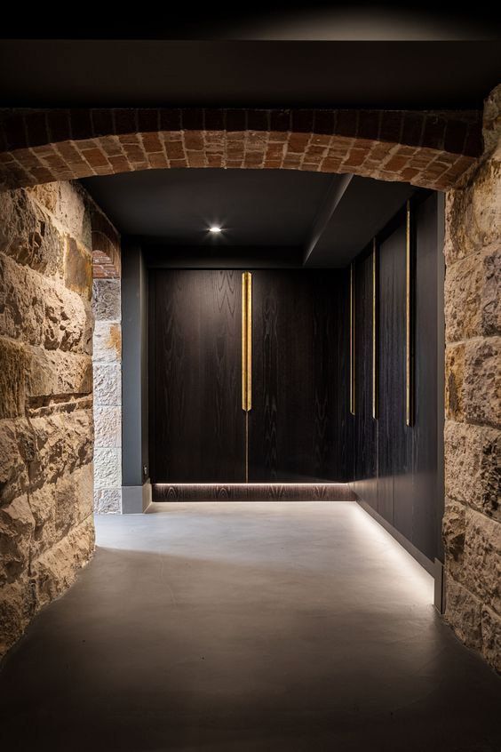 Modern hallway with stone walls and sleek lighting.