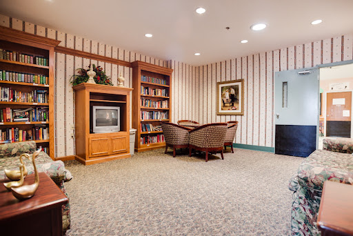 Cozy living area featuring a bookshelf, comfortable seating, and a television.