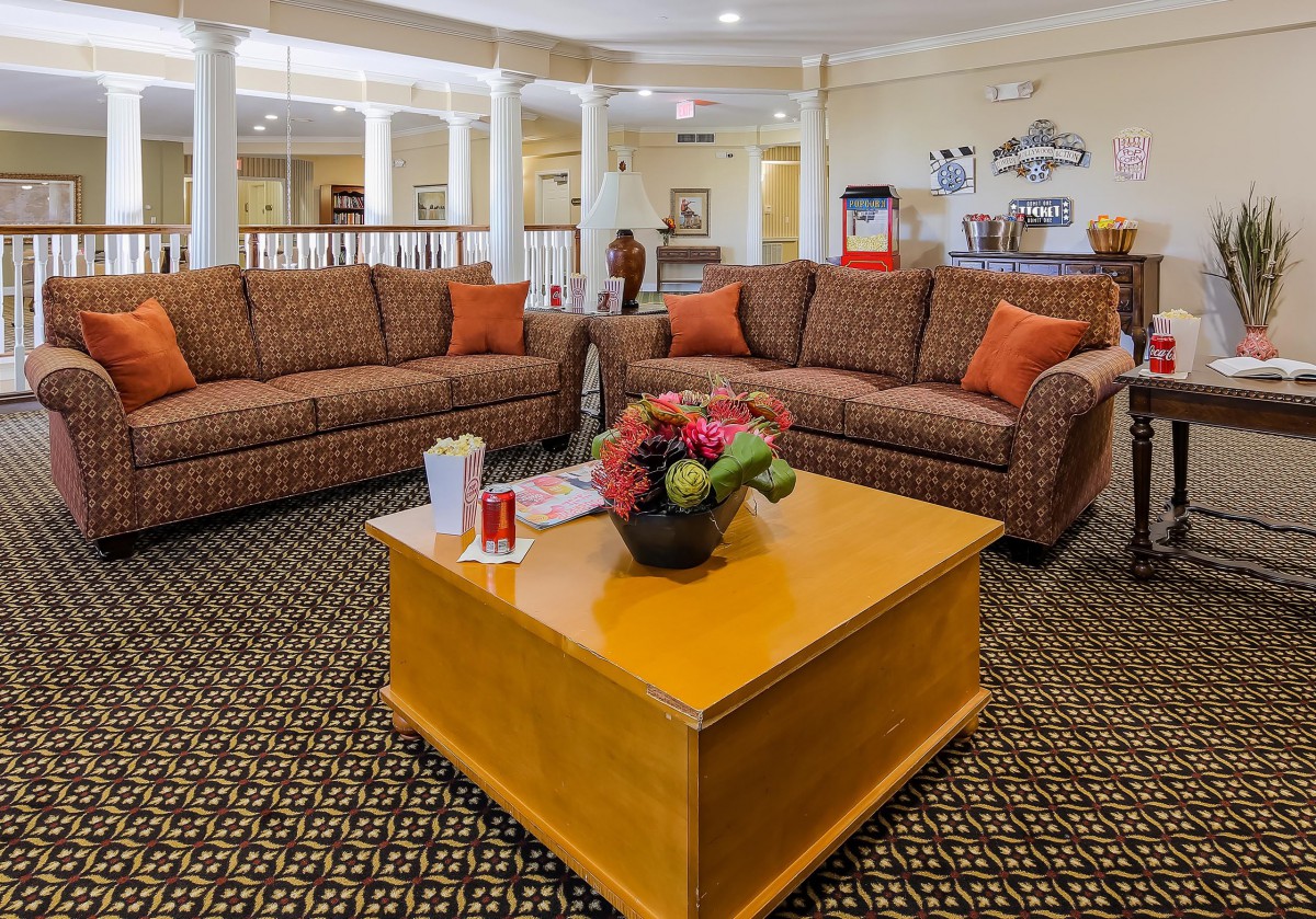 Cozy seating area with sofas and a coffee table in a welcoming lobby.