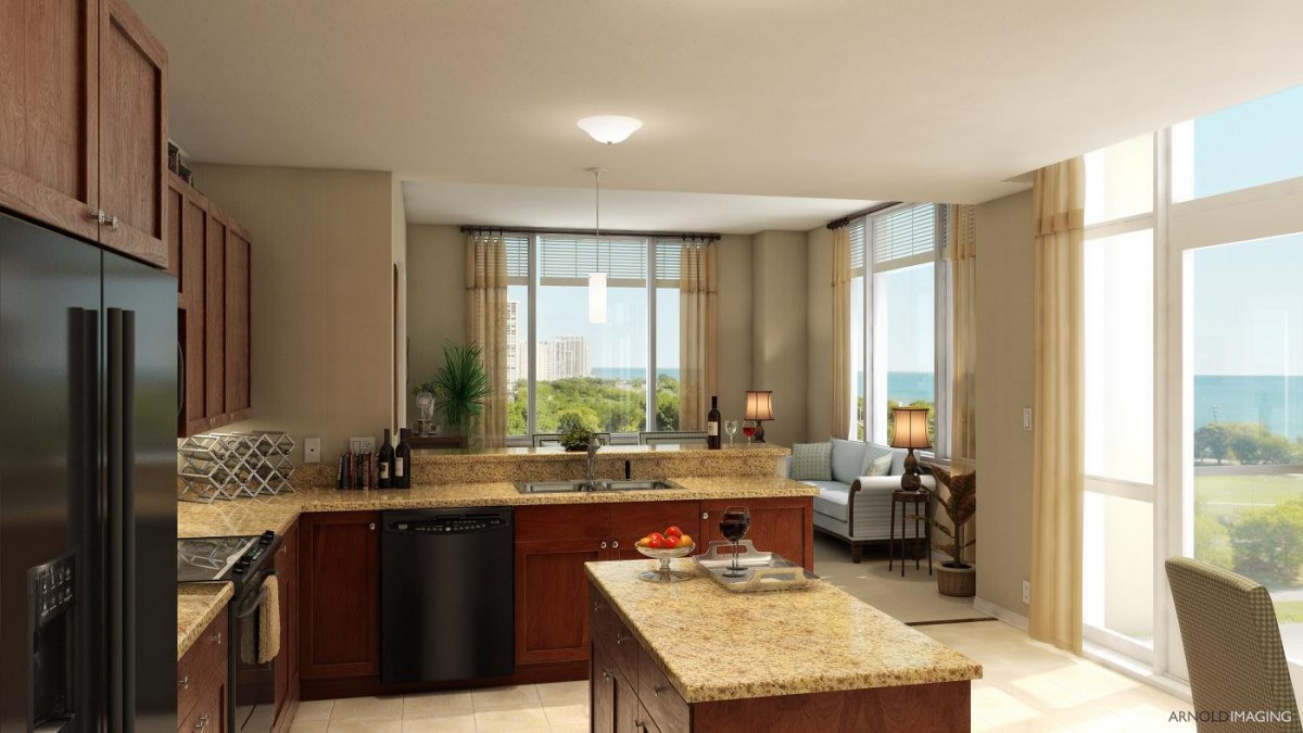 A modern open space design featuring a kitchen with an island and an adjoining living area.