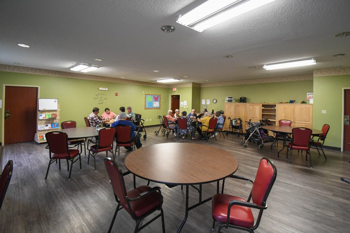 A group of people gathered in a community center for a meeting.