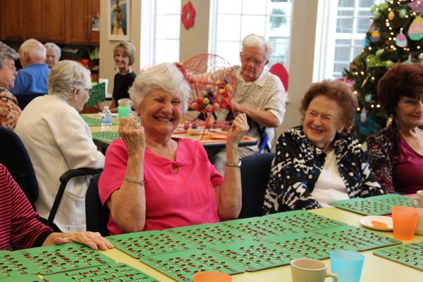 Elderly women enjoying a game of bingo together in a community setting.