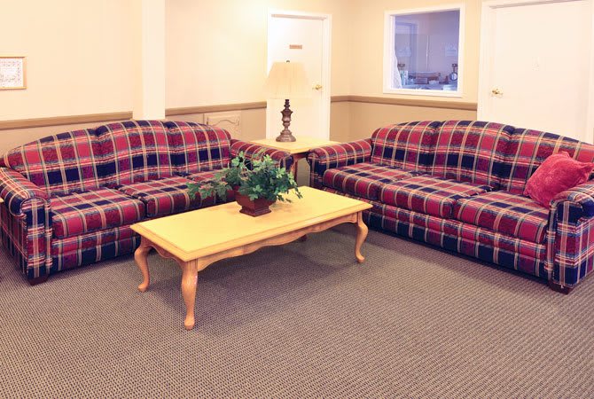 A cozy living room with plaid sofas and a wooden coffee table.