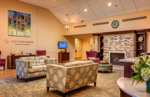 A cozy lounge area featuring comfortable seating and a stone fireplace, perfect for relaxation.