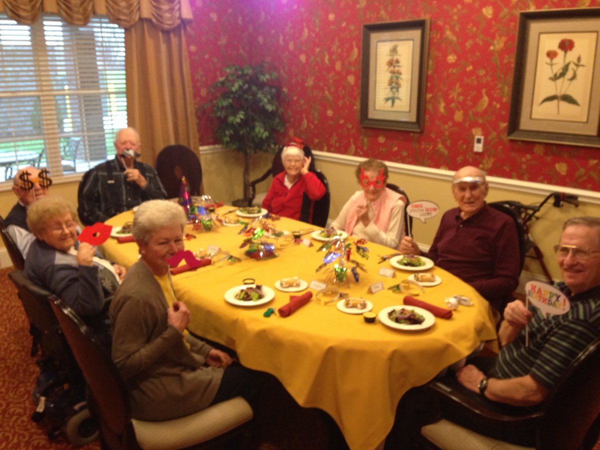A group of seniors enjoying a meal together at a beautifully decorated table.