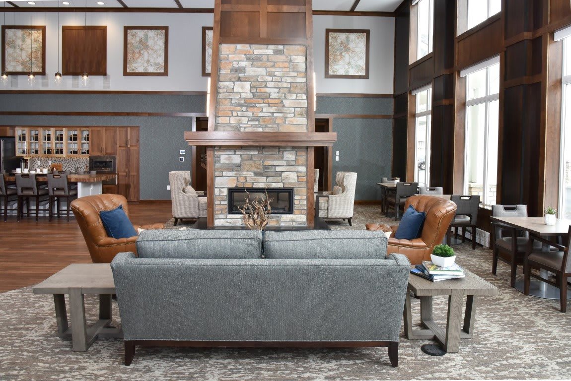 A modern living room with a central fireplace, surrounded by comfortable seating and elegant decor.