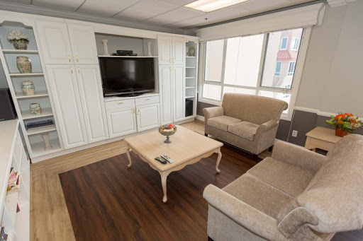 A cozy and modern living room with a comfortable sofa, coffee table, and a television.