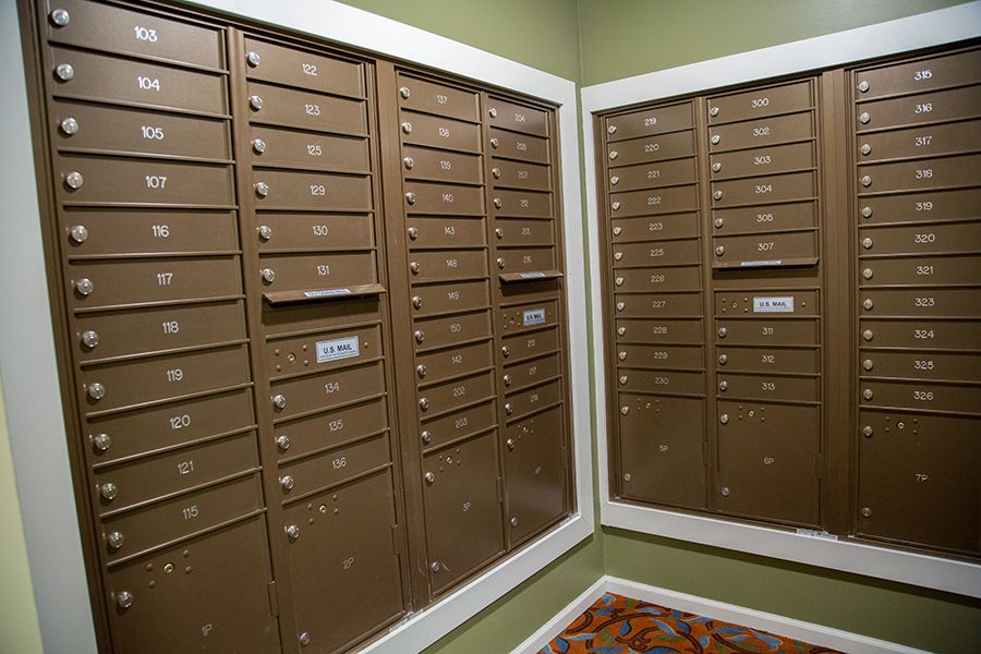 An indoor mailroom featuring neatly organized metal mailboxes.