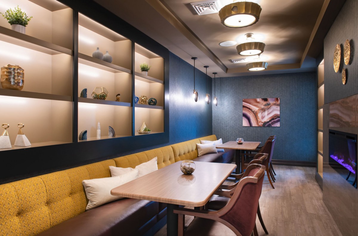 A modern restaurant interior featuring stylish seating and warm lighting.
