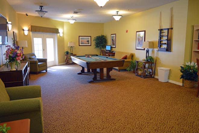 A cozy game room featuring a pool table and comfortable seating.