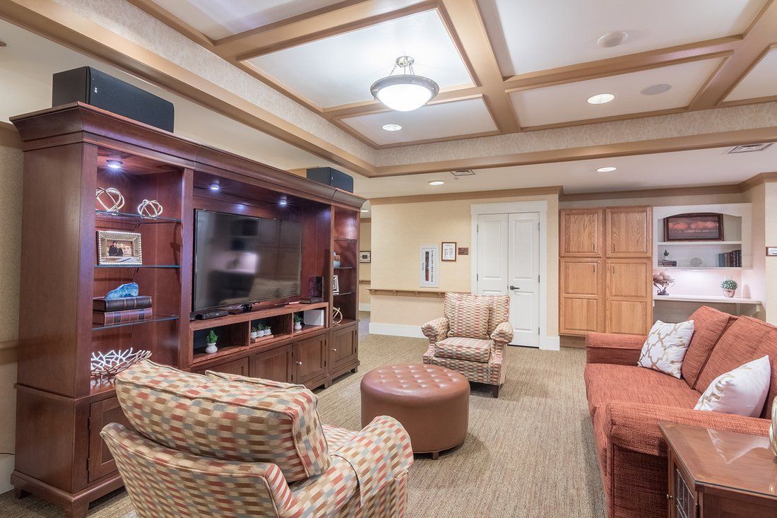A cozy living room with an entertainment center and comfortable seating.