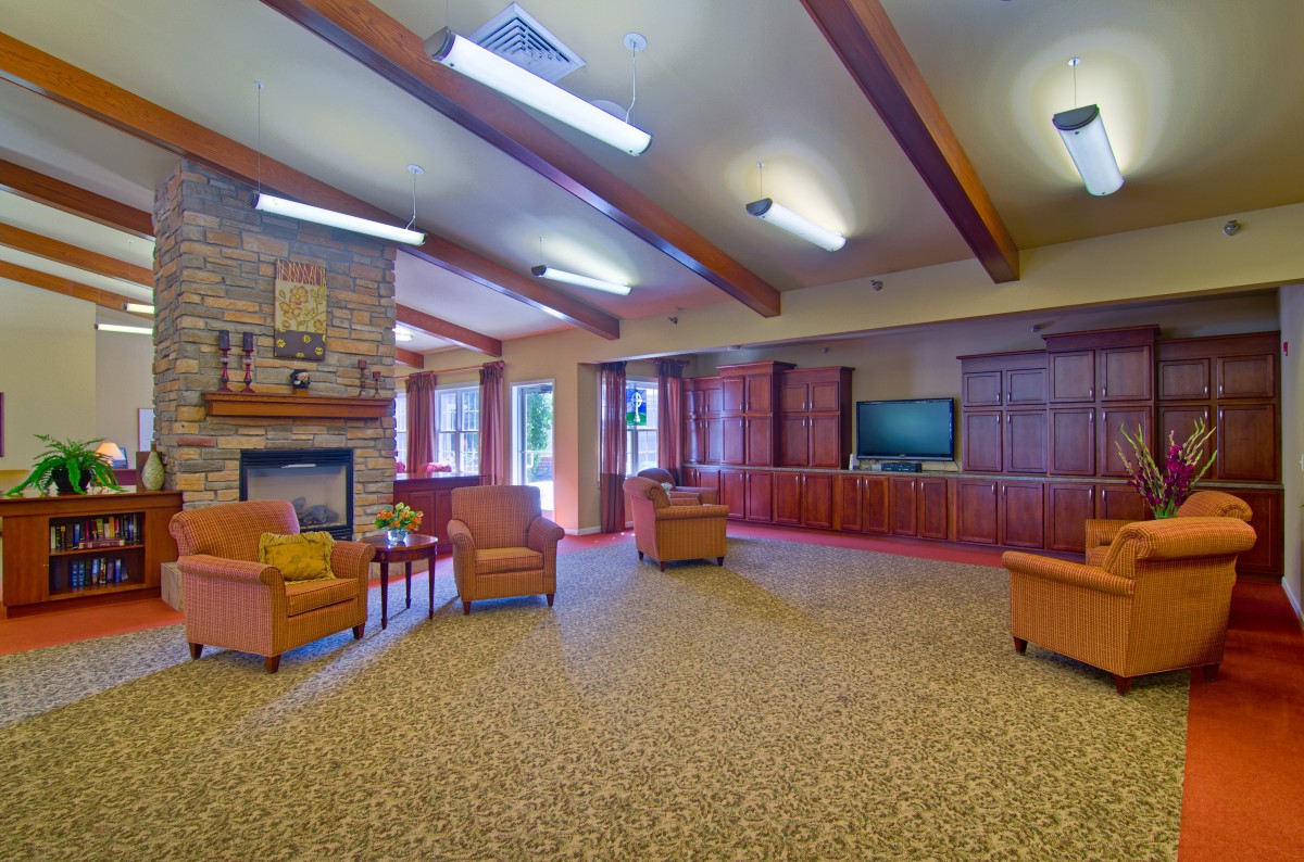 Spacious living room with comfortable seating, a fireplace, and a television.