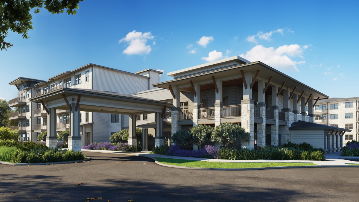 A modern residential building with landscaped surroundings and a covered entrance.