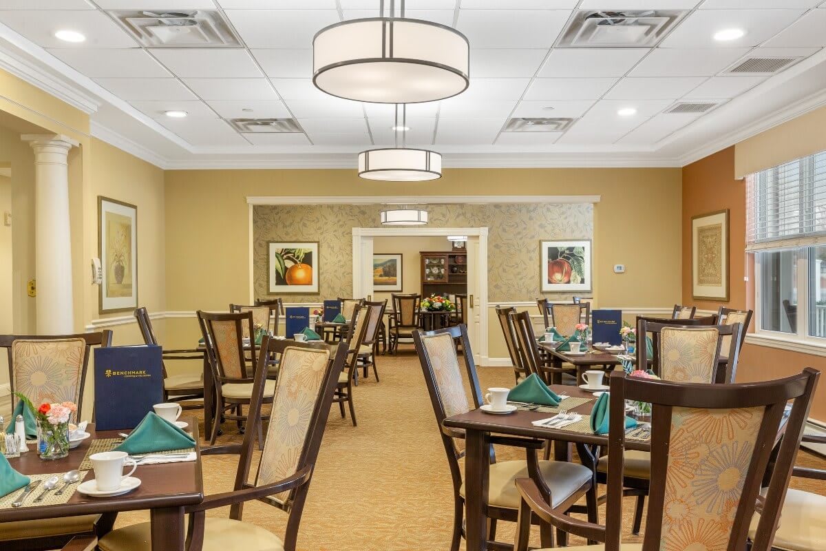 A well-lit dining area with neatly arranged tables and chairs.