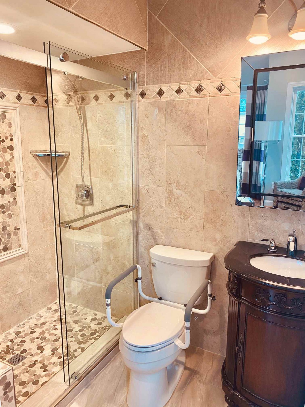 A modern bathroom with a glass shower, toilet, and sink.