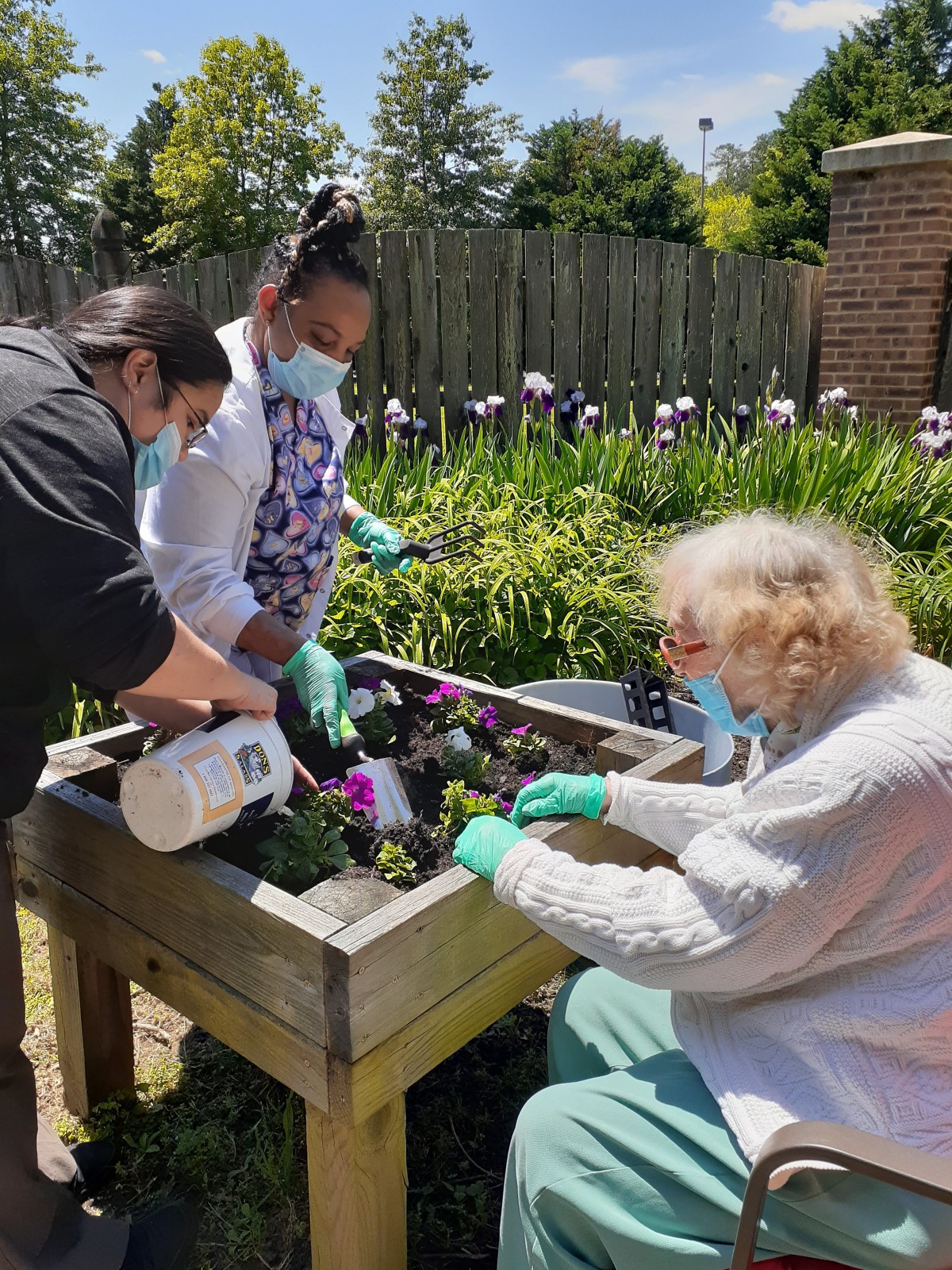Group of people engaged in gardening activities together.
