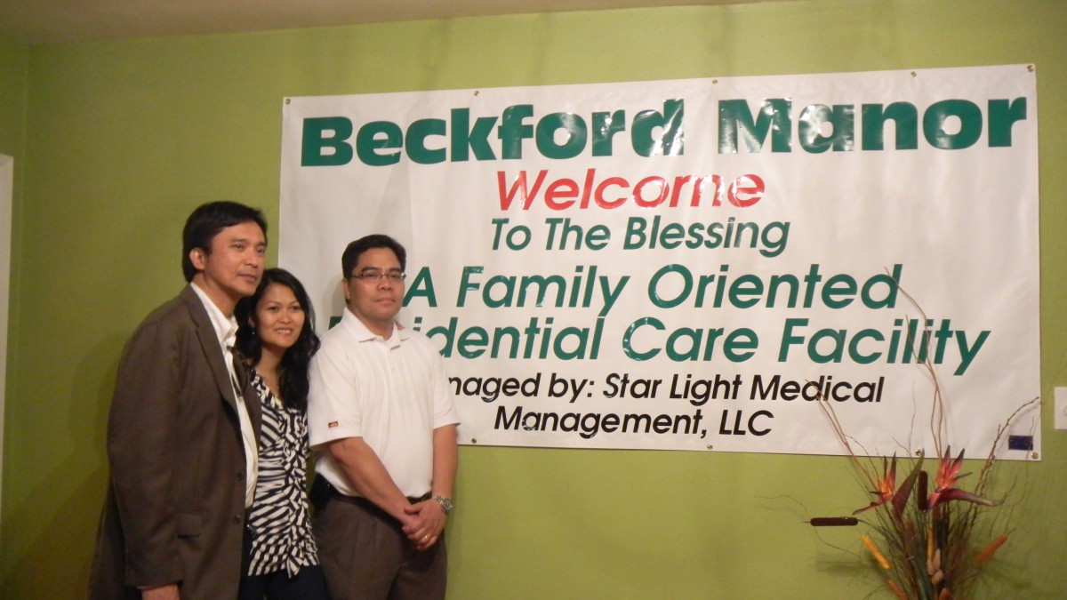 A group of people standing in front of a banner at an event.