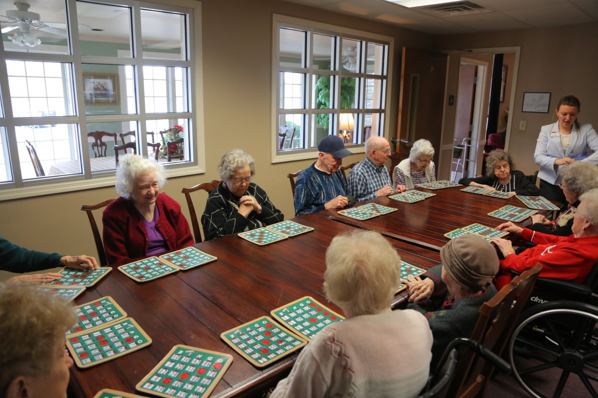 A group of seniors enjoying a game of bingo in a community room.