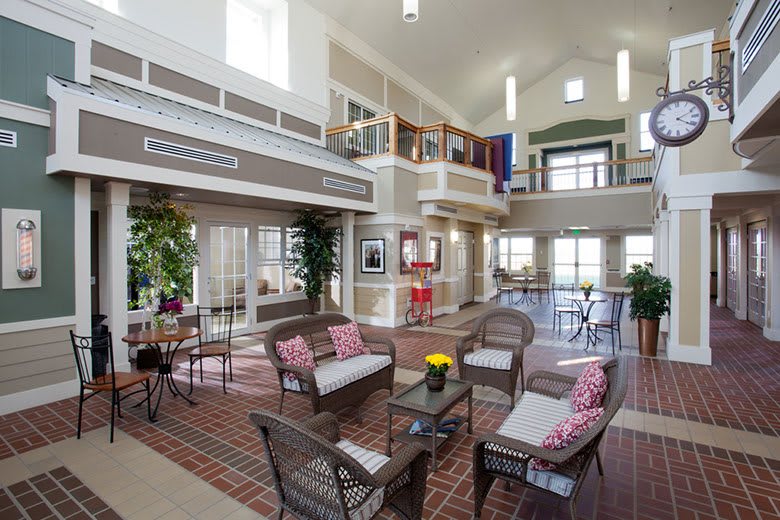 A spacious and modern living area with loft design, featuring comfortable seating and abundant natural light.