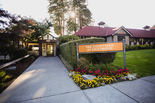 The welcoming entrance of the Countryside Resort, adorned with vibrant flowers and lush greenery.