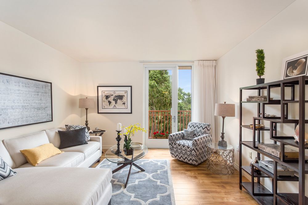 A bright, cozy living room with modern decor and access to a balcony.