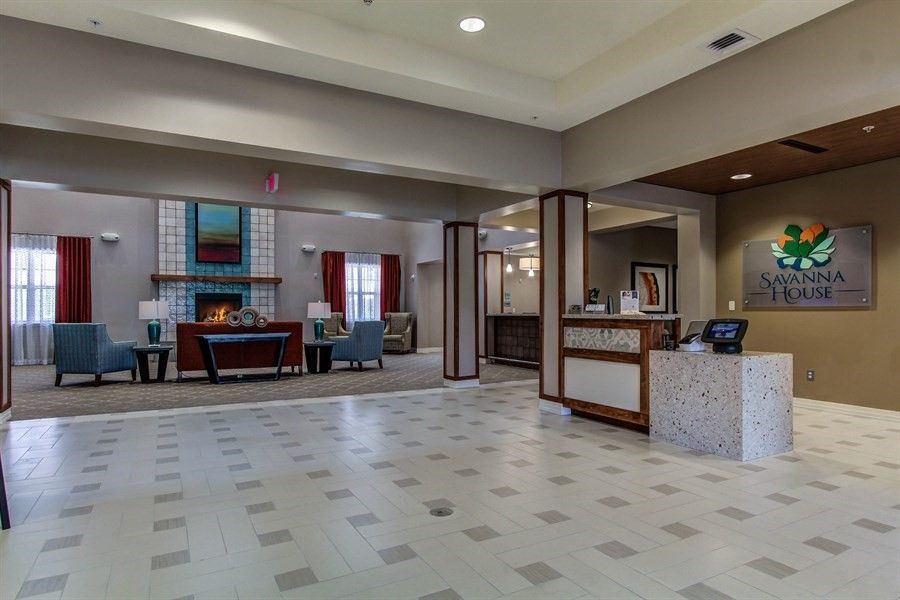 A spacious and modern lobby with comfortable seating and a reception desk.