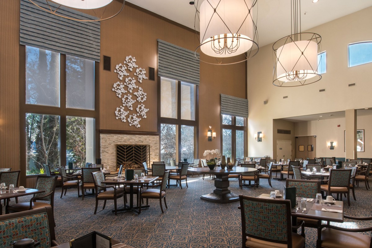 Spacious restaurant dining area with elegant decor and high ceilings.
