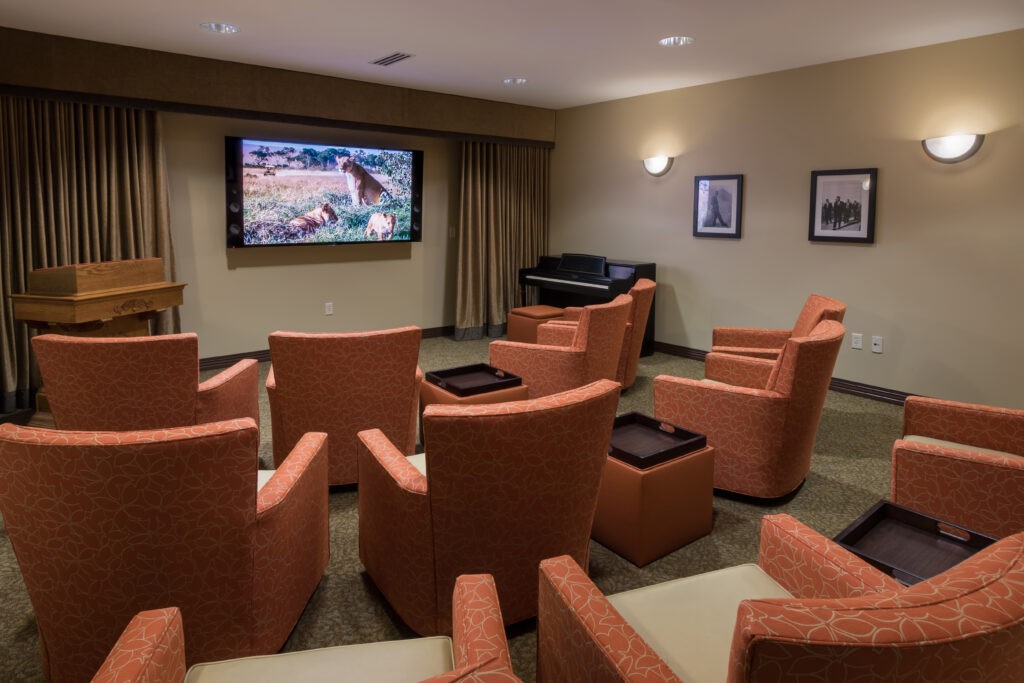 A cozy theater room with comfortable seating and a large screen for viewing.