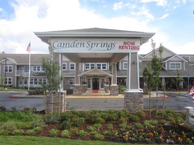 Entrance of a retirement home with well-maintained landscaping.