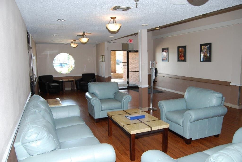 A comfortable lounge area with armchairs and a coffee table, ideal for waiting or relaxation.