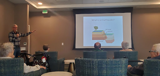 A presentation taking place in a conference room with attendees seated and viewing the screen.