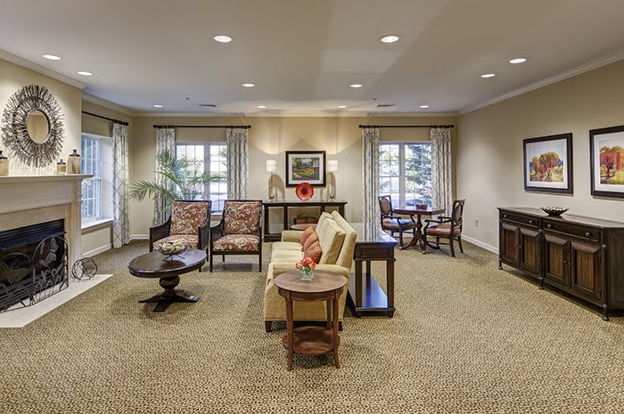 A cozy living room featuring elegant furniture and ample natural lighting.