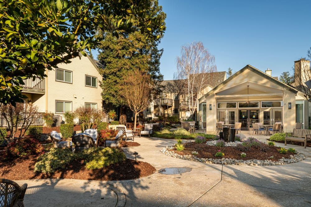 A scenic view of a landscaped garden area with patios and surrounding buildings.