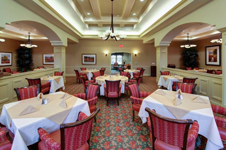 An elegant restaurant dining area with neatly arranged tables and chairs.