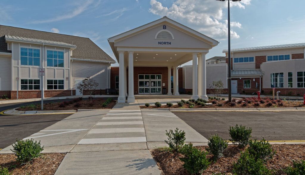 A building entrance with prominent pillars and a well-maintained pathway.