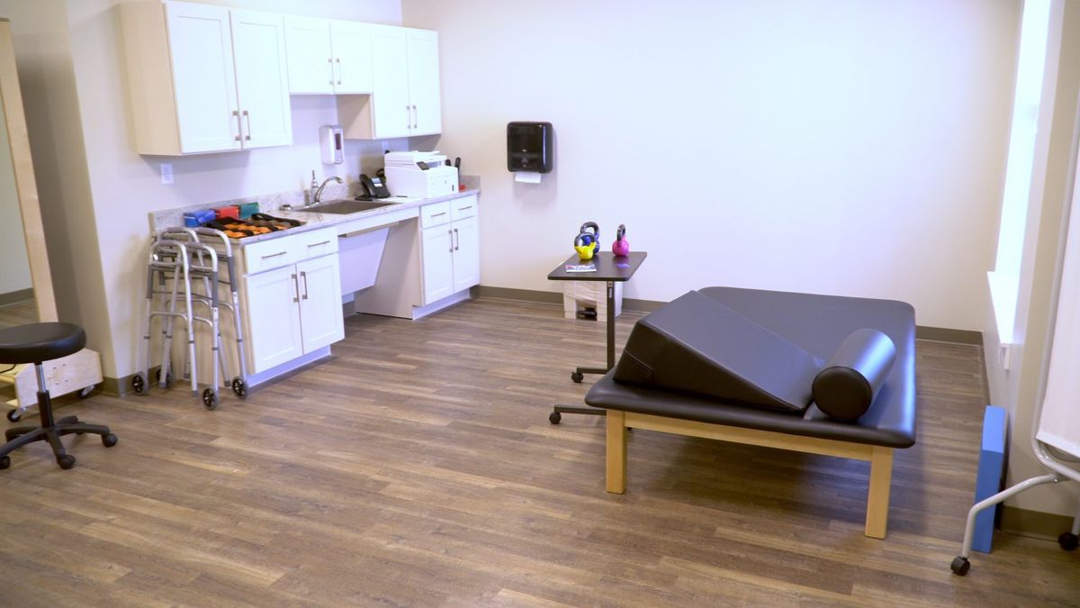 A well-equipped therapy room with exercise and rehabilitation equipment.