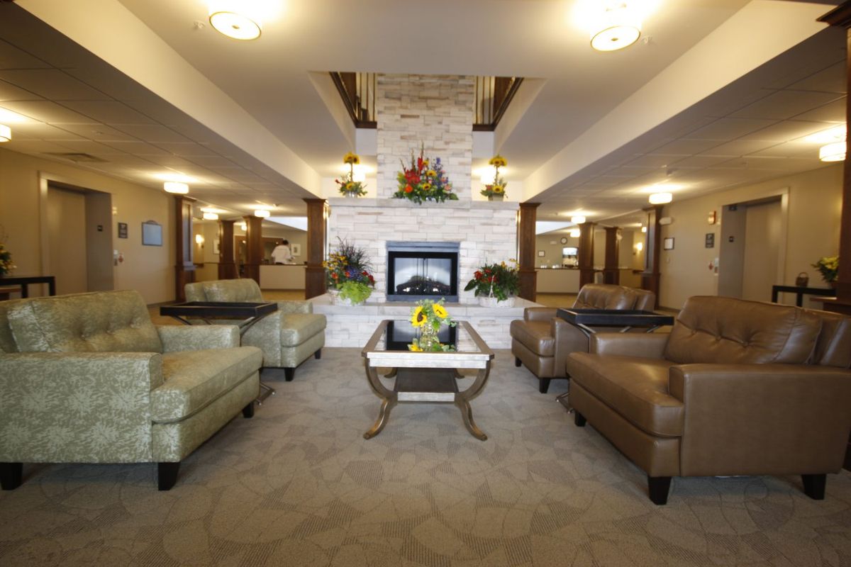 A spacious and elegantly designed living room with a fireplace and comfortable seating.